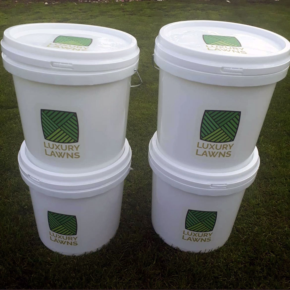 Image of four luxury lawns buckets containing fertiliser.
