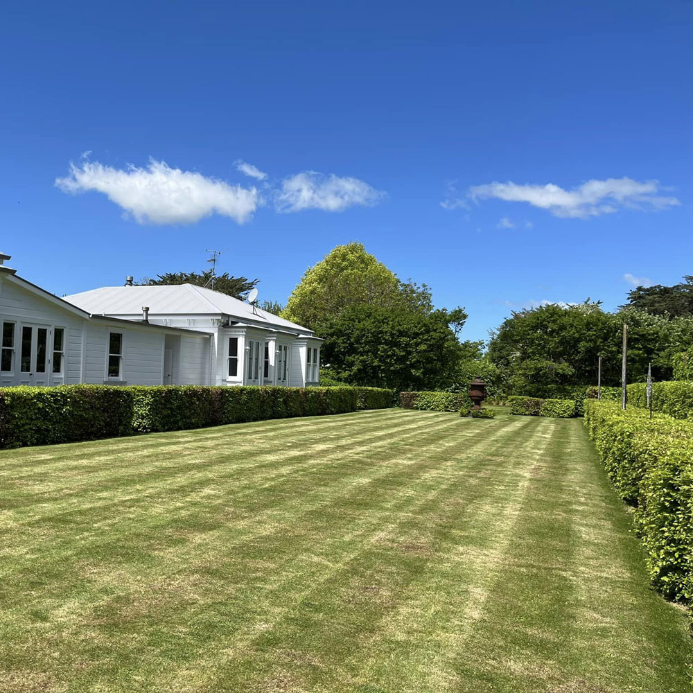 Image of house and lawn - freshly mowed.